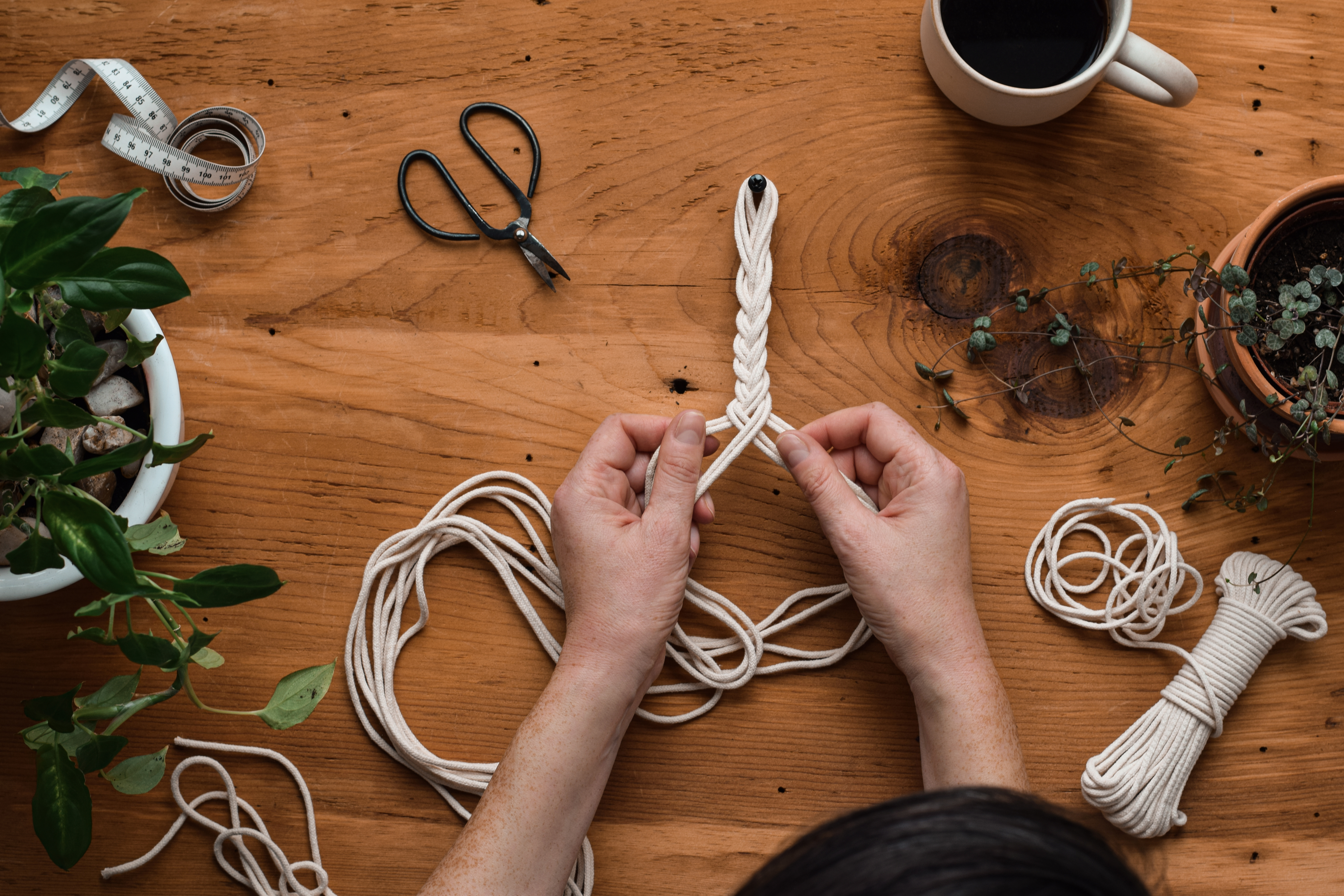 A person tying yarn together