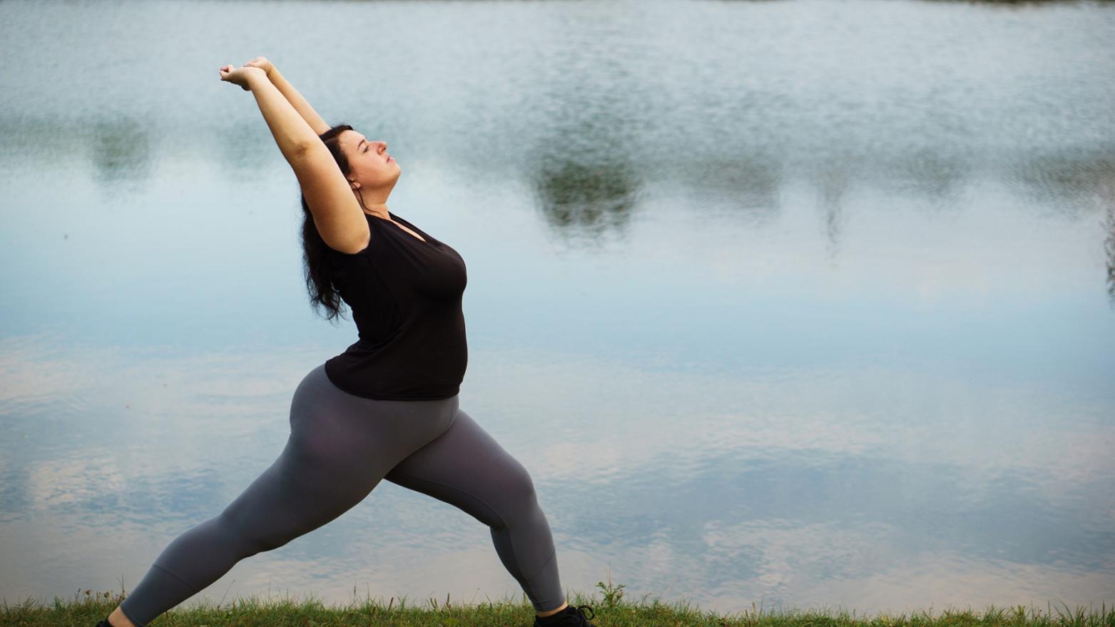woman doing yoga pose on beach